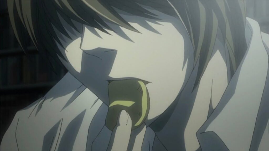 Alt Text: Light Yagami eating a potato chip with intensity in Death Note.